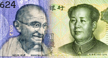 Portraits Of Mahatma Gandhi On Indian Rupees And Mao Zedong On Chinese Yuanes. Business Concept