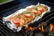grilled salmon wrapped in foil on a barbecue