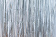 Silver foil glitter tinsel curtain. Shimmer fringe holiday Wedding New Year Christmas decoration. Birthday Party concept

