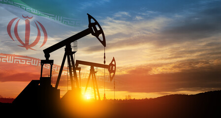 Wall Mural - Oil drilling derricks at desert oilfield with Iran flag.