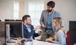 © Bojan - Business people laughing at funny joke in office. Friendly work team enjoying positive emotions together, happy colleagues staff group having fun at office break.