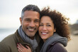 © dvoevnore - Middle age mixed race cheerful couple enjoying dating time on ocean beach
