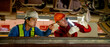 © narong - Wide image of engineer and technician workers check and maintenance under the train with use light tube to support in train factory workplace.
