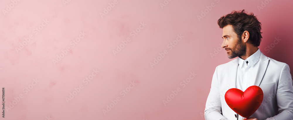 Handsome man in white suit with red heart on pink background. concept ...
