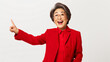 Surprised senior asian lady pointing upper left corner, checking out promo offer and smiling amazed, standing in red blazer over white background