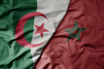 Wall Mural - big waving national colorful flag of algeria and national flag of morocco .