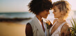 Destination wedding bridal portrait of young queer interracial lesbian couple embracing outside on tropical island beach