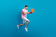 © deagreez - Full length profile photo of impressed cheerful man jump run use netbook empty space isolated on blue color background