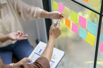 Wall Mural - Business People working on sticky notes creative writing down ideas on post it notes professional investor start up project business.