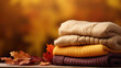 stack of knitted sweaters on autumn background, generative ai