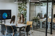 © BGStock72 - Young business women discussing in cubicle at the office