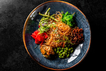 Poster - Salad with funchoza and vegetables on table in restaurant