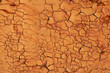 Cracked surface texture. The brown paint on the metal surface was cracked and rusty from age.