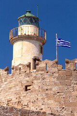 Wall Mural - Old stone lighthouse on the breakwater in Rhodes.