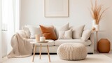 Fototapeta  - Knitted pouf near white fabric sofa with blanket and terra cotta pillows Scandinavian hygge style home interior design of modern