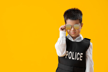 Wall Mural - Cute little policeman on yellow background