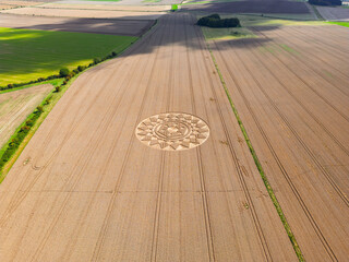 Canvas Print - Aerial view of an intricate geometric crop circle formation in a wheat field in Wiltshire, England, UK