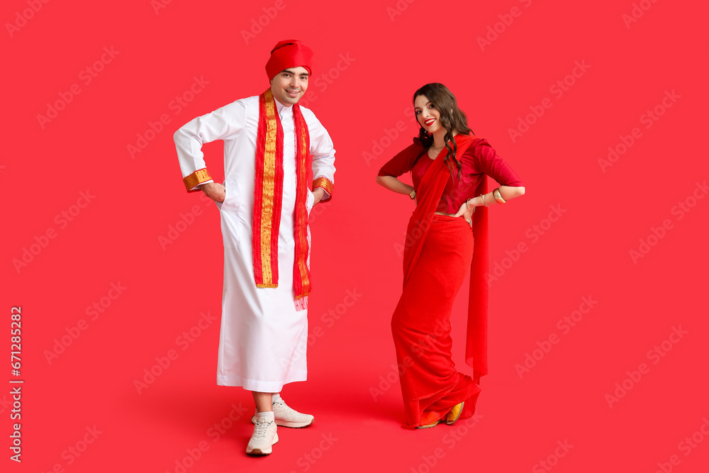 Beautiful Indian couple on red background