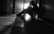 Silhouetted of sad photo. Lonely man sitting on the floor.He is unhappy and sad.He is depression.unlove,unhappy,fail.Photo concept for Disease and depression.