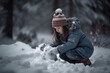© Kenishirotie - Young child building snowman during winter season