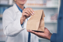 Woman, Pharmacist And Hands With Medication For Patient, Healthcare Or Paper Bag At The Pharmacy. Closeup Of Female Person Or Medical Professional Giving Pills, Drugs Or Pharmaceuticals To Customer