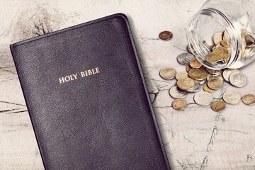 Holy Bible book and money coins