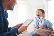 © Azeemud/peopleimages.com - Happy little girl, father and tablet with tickets for travel, vacation or holiday getaway together at home. Dad and excited daughter, child or kid and boarding pass for weekend journey or flight trip
