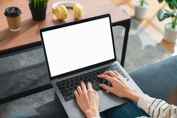 Wall Mural - Woman hand type on the keyboard on laptop with mockup of blank screen for the application.