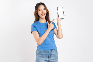 Beautiful Asian woman holding smartphone mockup of blank screen and shows hand sign on white background.