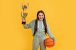 sport success. happy girl won prize. back to school. Celebrating success. winning the game. sport champion. teen girl with basketball ball and champion cup. happy basketball champion