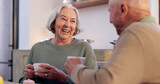Fototapeta  - Funny, retirement and a senior couple drinking tea in the dining room of their home together in the morning. Smile, relax or laughing with an elderly man and woman in apartment for romance and coffee