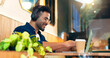 © HockleyMedia/peopleimages.com - Happy man in cafe with headphones, typing on laptop and remote work, reading email and web in restaurant. Computer, freelancer smile and copywriter in coffee shop, listen to music and radio at table