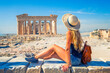 Young female tourist looking at Parthenon Athens greece temple