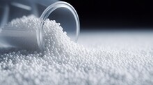 Secondary Granule Made Of Polypropylene, White Plastic Pellets Crumbles To The Table. Plastic Raw Materials In Granules For Industry. Polymer Resin. Raw Plastic Recycling Concept