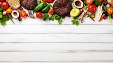 Summer BBQ Or Picnic Food Top Border. Variety Of Burgers, Grilled Meat, Vegetables, Fruits, Salad And Potatoes. Overhead View On A White Wood Background. Copy Space.