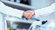 © Phindulo T/peopleimages.com - Handshake, partnership and laboratory scientist, people or team work, collaboration and cooperation on science. Welcome, thank you and partner handshake for healthcare trust, agreement or onboarding
