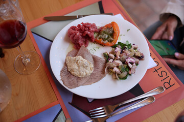 Wall Mural - A delicious starter from Piedmont. Steak tartare, carpaccio, stuffed peppers, and salad