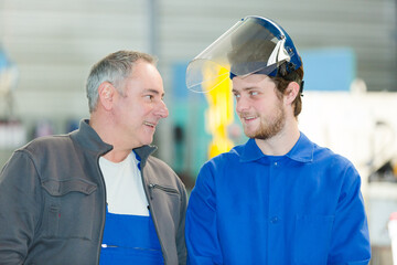 portrait of two male manual workers in factory