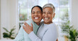 © Charlize D/peopleimages.com - Hug, love and portrait of mother and daughter in home for bonding, relationship and smile together. Family, happy and mature mom embrace adult woman for mothers day, support and care in living room