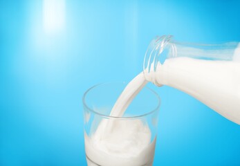 Canvas Print - Pouring fresh tasty milk in glass