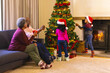 © Wavebreak Media - Happy african american grandparents and grandchildren and decorating christmas tree, copy space