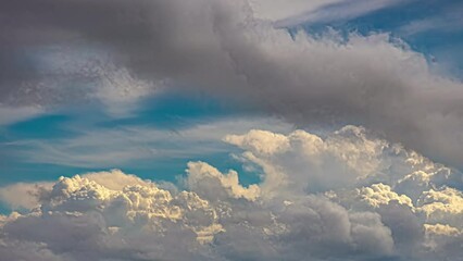 Wall Mural - Timelapse shot of white fluffy clouds moving along blue sky at daytime. Cumulus cloud movement.