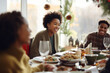 © Jasmina - African American family having dinner during thanksgiving day. Happy people celebrating holiday, eating and laughing together