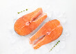 fresh salmon steaks sea fish peeled laid out on pieces of ice decorated sprig of greens isolated on white background top view for your design. healthy food. vitamins, omega b12 healthy fats for human