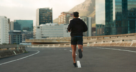 Canvas Print - Sports, back and running in morning on city, street and bridge for fitness, workout and marathon training. Athlete, man or exercise on South Africa road for wellness, health or triathlon performance