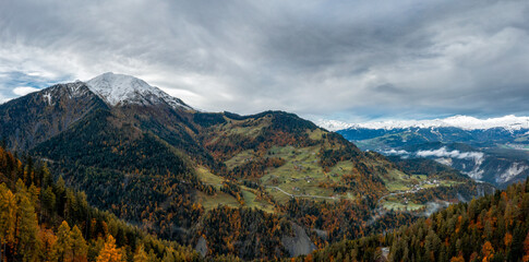 Poster - mountain landscape in the Swiss Alps with snow-capped peaks and autum color forest