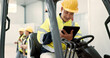 © N Felix/peopleimages.com - Construction, tablet and man in forklift vehicle for maintenance, planning and renovation in building. Civil engineering, machine and contractor on digital tech for online design, project and report