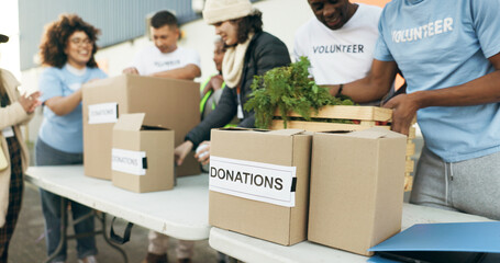 Group of people, volunteering and food boxes on table for charity event with care, kindness and trust. Community donation, men and women at ngo with grocery package distribution at non profit project