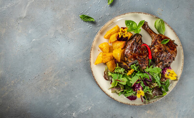 Wall Mural - roasted duck leg with potatoes and lettuce salad. Long banner format. top view