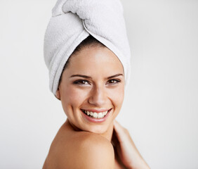 Poster - Smile, skincare and woman with towel in a studio for health, wellness and natural face routine. Happy, beauty and portrait of young female model with facial dermatology treatment by gray background.